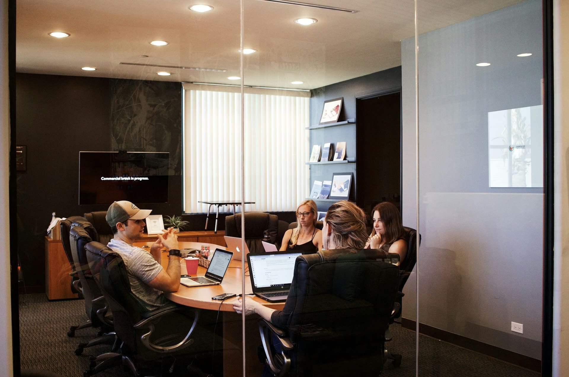 Colleagues meeting in a glass conference room
