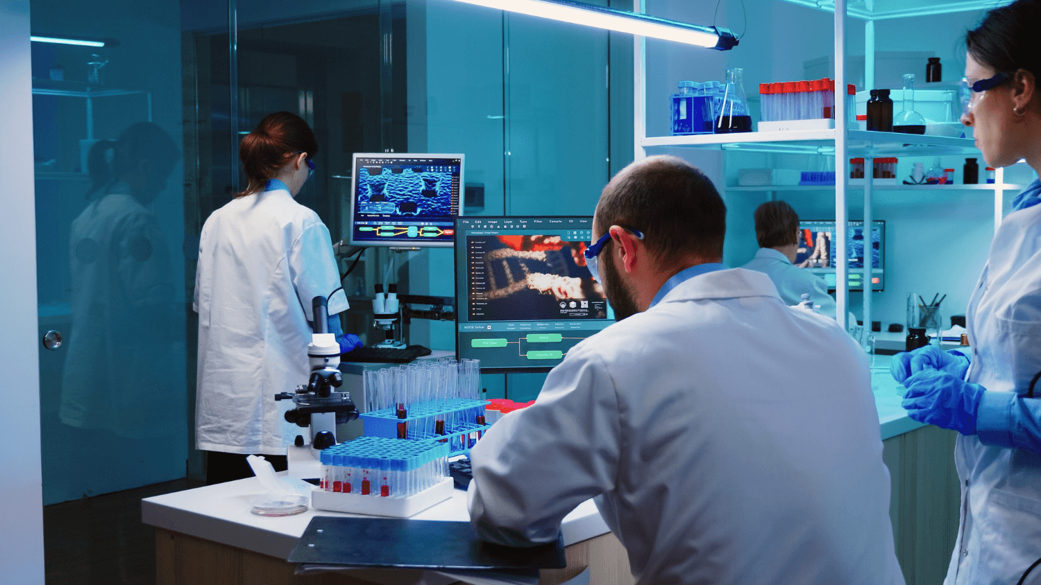 Scientists reviewing diagnostic imaging on lab workstations